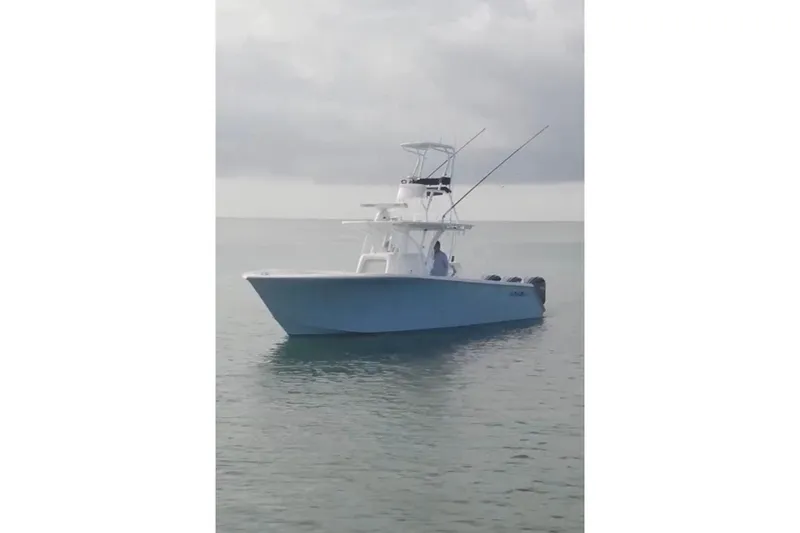 Slide: The Image of 2017 SeaHunter 35 Tournament boat on calm water under cloudy sky. - 8