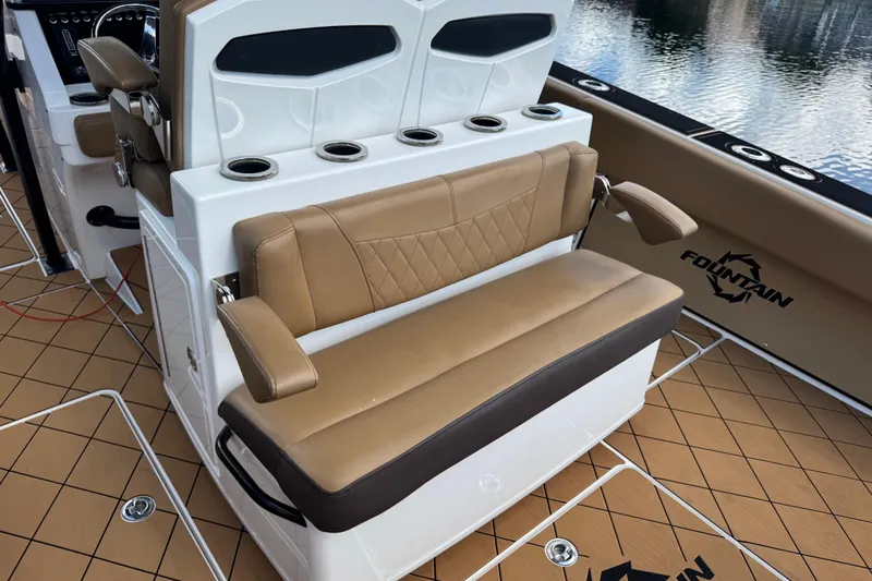 Slide: The Image of 2020 Fountain 38 Center Console boat interior with tan seating and cup holders. - 13