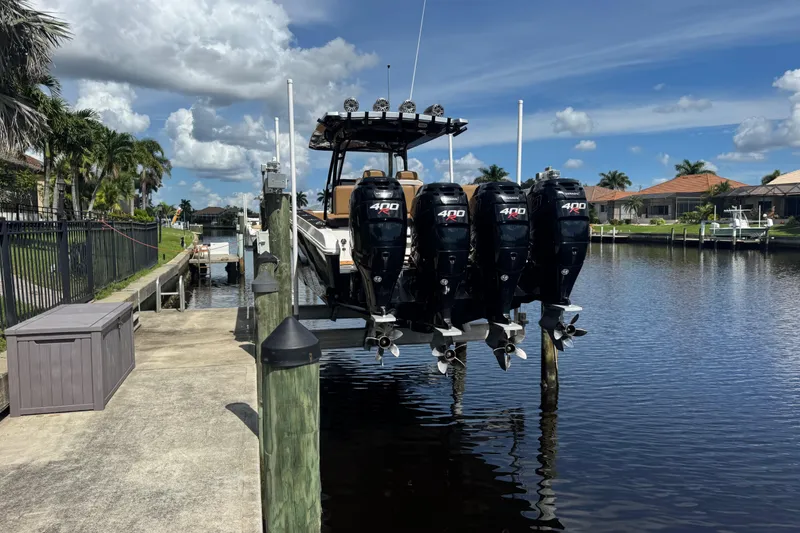 Slide: The Image of 2020 Fountain 38 Center Console boat with four powerful outboard engines docked by a canal. - 9