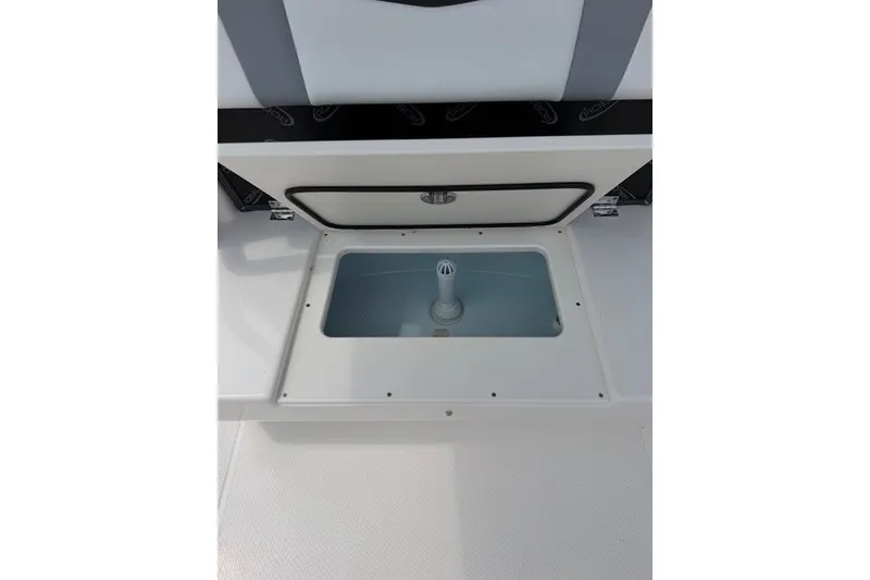 Slide: The Image of 2026 Robalo R270 Center Console livewell compartment, open with visible interior. - 42