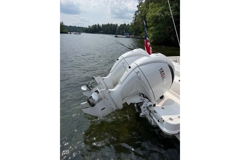 Slide: The Image of 2026 Robalo R270 Center Console with twin Yamaha outboard motors on a lake. - 1