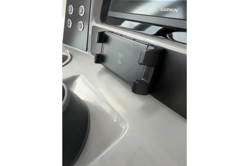 Slide: The Image of 2026 Robalo R270 Center Console dashboard with Garmin display and phone holder. - 22