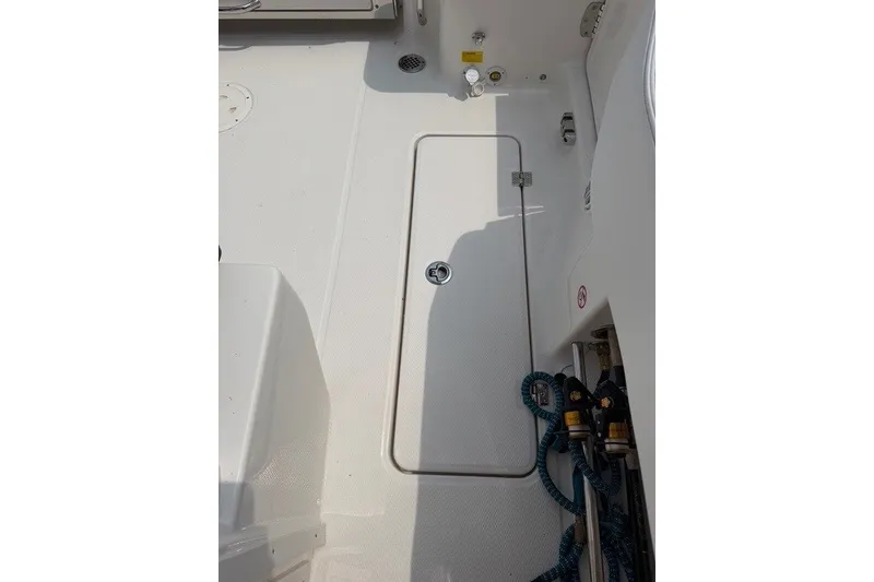 Slide: The Image of 2026 Robalo R270 Center Console boat deck with storage hatch and ropes. - 38