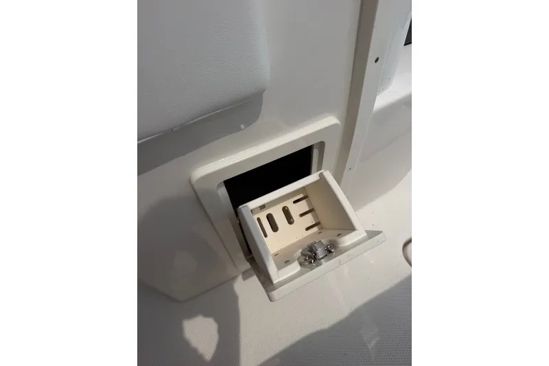 Slide: The Image of 2026 Robalo R270 Center Console boat with open storage compartment detail. - 45