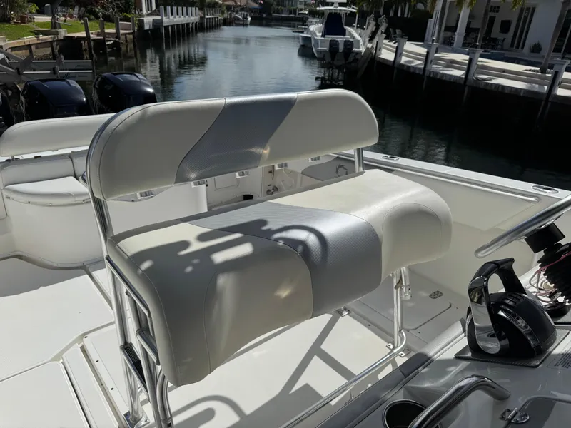 Slide: The Image of 2008 Fountain 34 Center Console boat with cushioned seating, docked by a canal. - 11