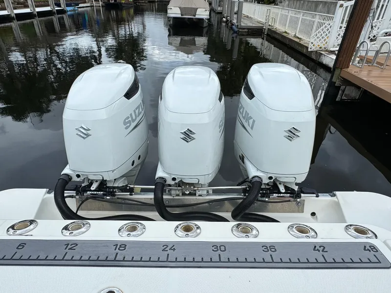 Slide: The Image of Three Suzuki outboard engines on a Hydra-Sports 3500 VX boat. - 10