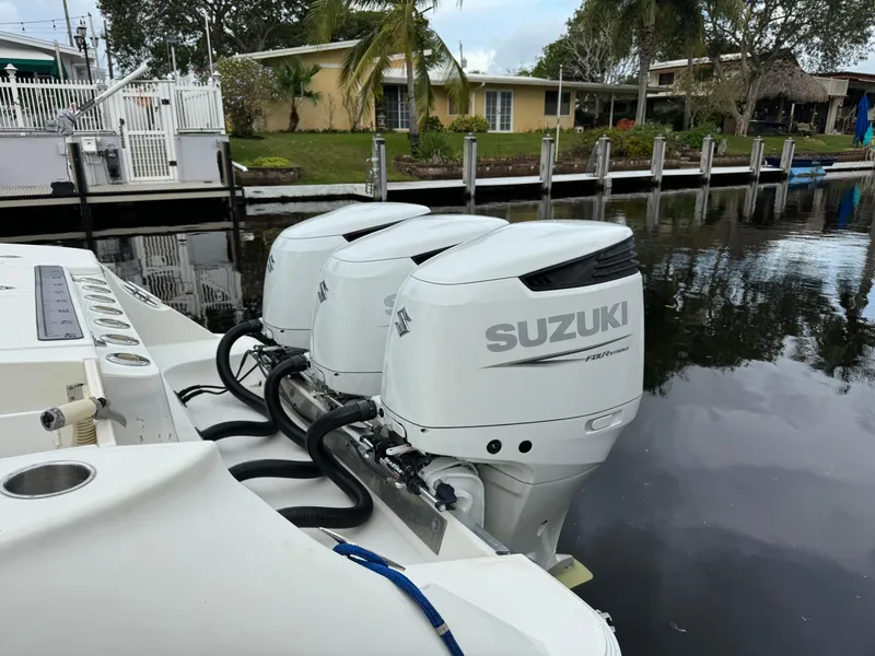 Slide: The Image of Hydra-Sports 3500 VX boat with Suzuki engines by the water. - 14