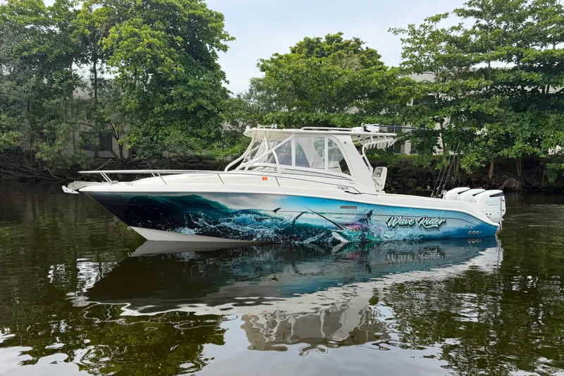 Slide: The Image of 2010 Hydra-Sports 3500 VX boat with vibrant ocean-themed graphics on calm water. - 4