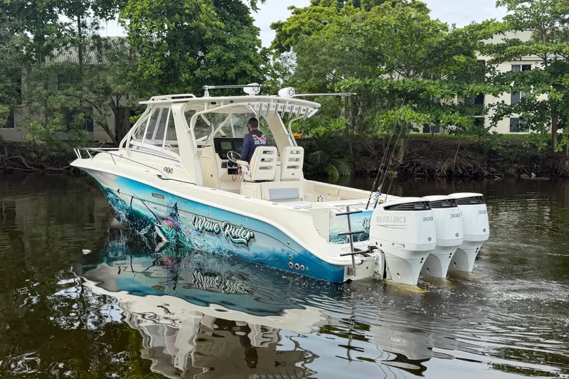 Slide: The Image of 2010 Hydra-Sports 3500 VX boat with vibrant "Wave Rider" graphics on a calm river. - 5