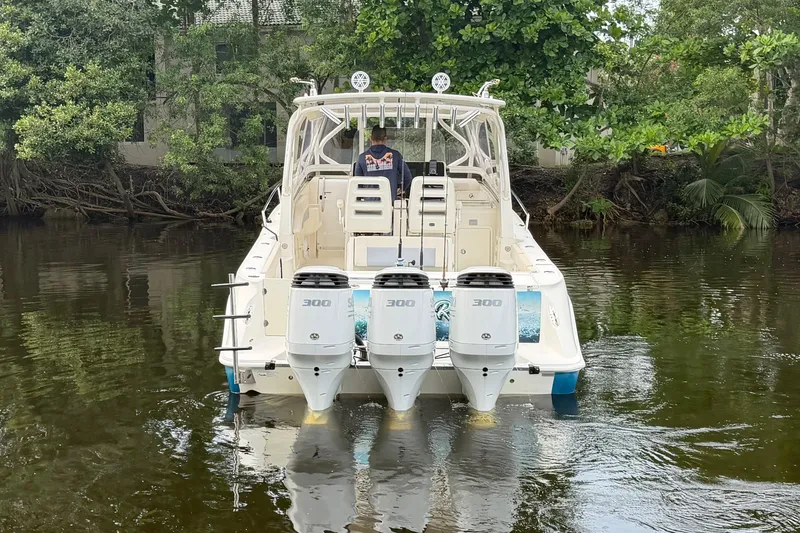 Slide: The Image of 2010 Hydra-Sports 3500 VX boat with triple engines on a calm river. - 7