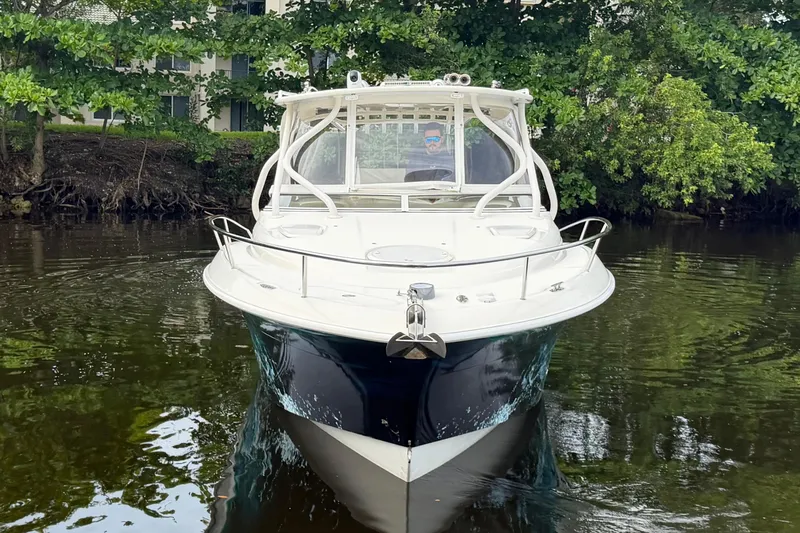 Slide: The Image of 2010 Hydra-Sports 3500 VX boat on calm water, surrounded by lush greenery. - 8