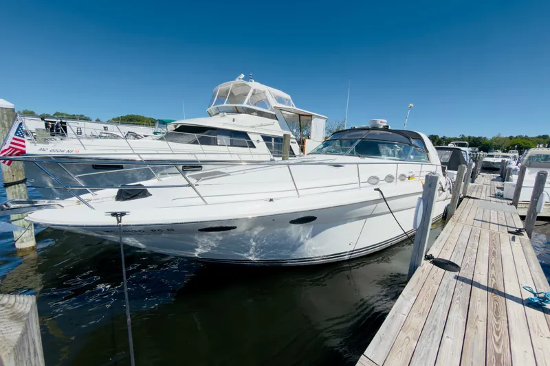 The Image of 1995 Sea Ray Sundancer 370 docked at marina under clear blue sky. - 0