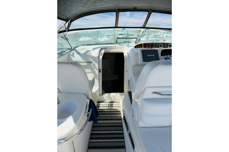Slide: The Image of Interior view of a 1995 Sea Ray Sundancer 370 yacht cockpit with white seating and controls. - 10