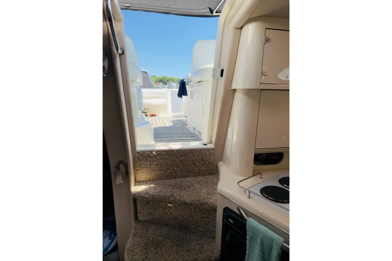 Slide: The Image of Interior view of 1995 Sea Ray Sundancer 370 yacht, showing stairs and kitchenette. - 11