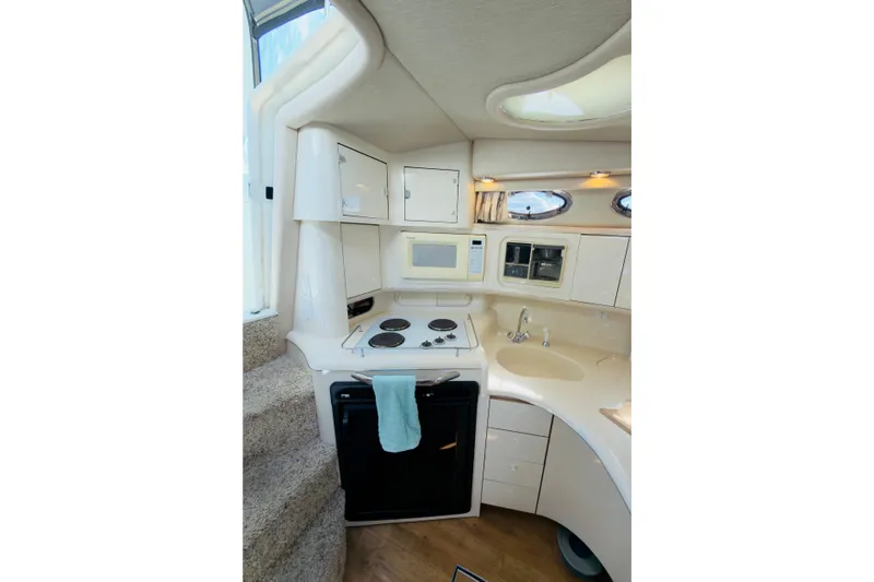 Slide: The Image of Interior of 1995 Sea Ray Sundancer 370 yacht kitchen with stove, microwave, and sink. - 12