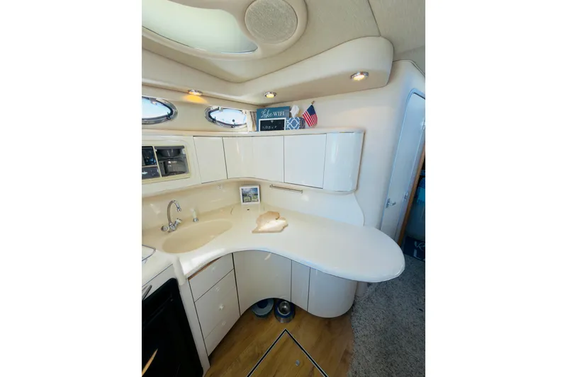 Slide: The Image of Interior of 1995 Sea Ray Sundancer 370 yacht, featuring a sleek, modern kitchen area. - 13