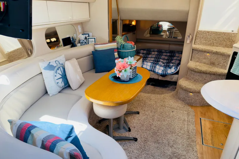 Slide: The Image of Interior of 1995 Sea Ray Sundancer 370 with cozy seating and nautical decor. - 15