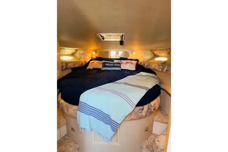 Slide: The Image of Cozy cabin interior of 1995 Sea Ray Sundancer 370 with plush bedding. - 16