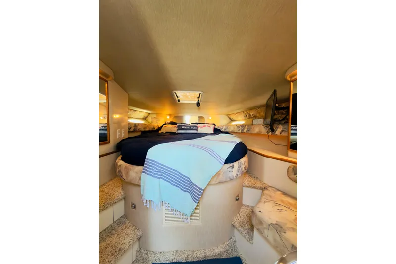 Slide: The Image of Interior cabin of 1995 Sea Ray Sundancer 370 with cozy bed and ambient lighting. - 17