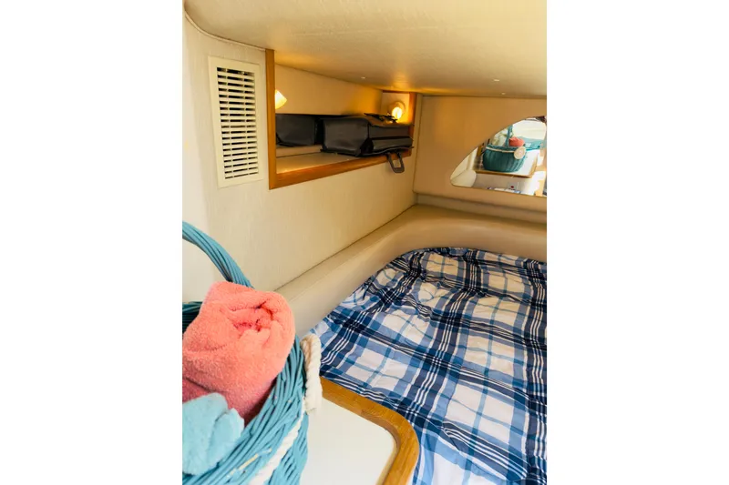 Slide: The Image of Cozy cabin interior of 1995 Sea Ray Sundancer 370 with plaid bedding and storage. - 21