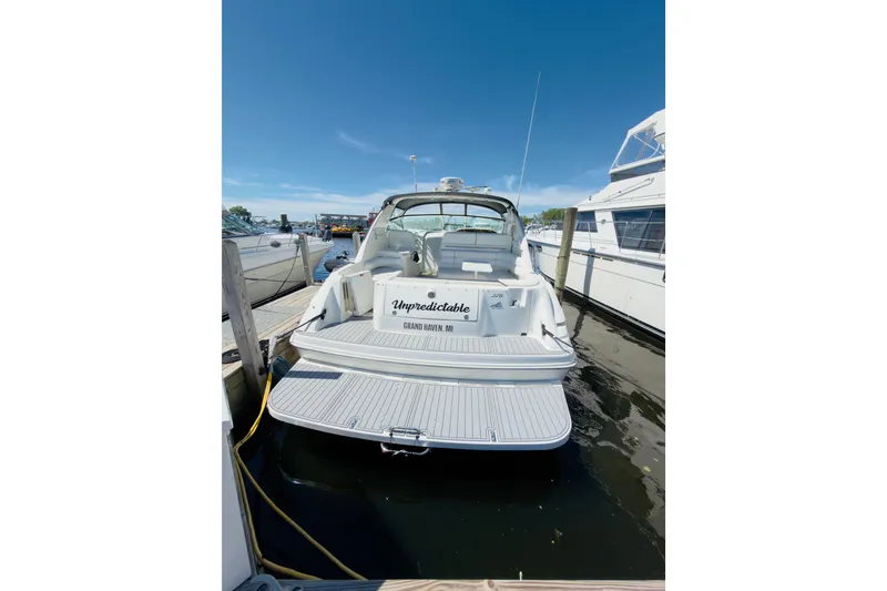 Slide: The Image of 1995 Sea Ray Sundancer 370 docked, rear view, clear sky, marina setting. - 3