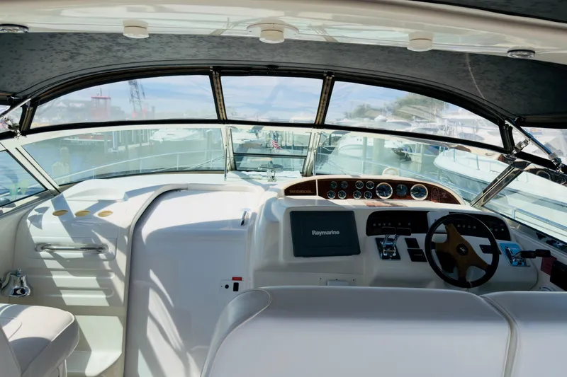Slide: The Image of Interior view of 1995 Sea Ray Sundancer 370 helm with steering wheel and navigation equipment. - 9