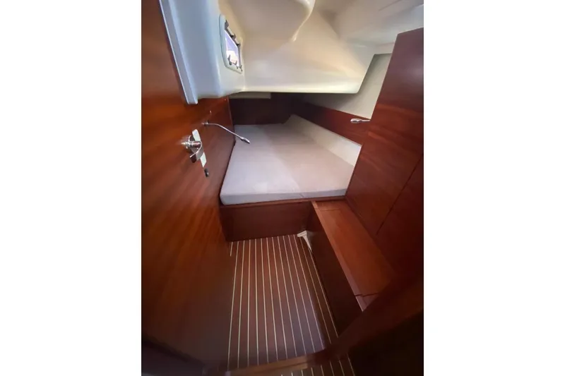 Slide: The Image of Cozy cabin interior of 2015 Salona 44 yacht with wooden finish and comfortable bedding. - 11