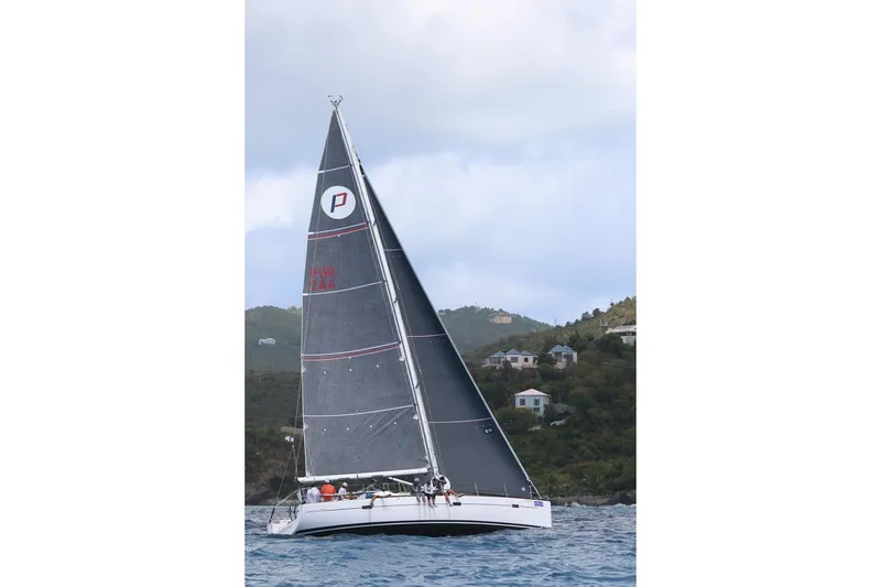 Slide: The Image of Sailing yacht Salona 44 (2015) gliding on water near coastal hillside homes. - 18
