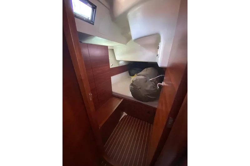 Slide: The Image of 2015 Salona 44 yacht interior cabin with wooden finish and storage space. - 14