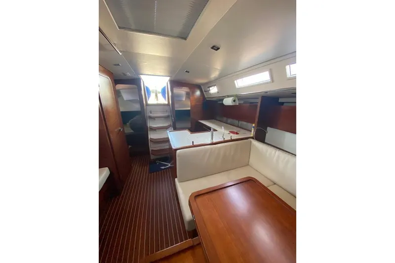 Slide: The Image of Interior of 2015 Salona 44 yacht with wooden flooring and white seating. - 13