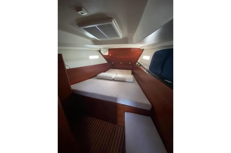 Slide: The Image of Interior cabin of 2015 Salona 44 yacht with wooden finish and cozy bedding. - 6