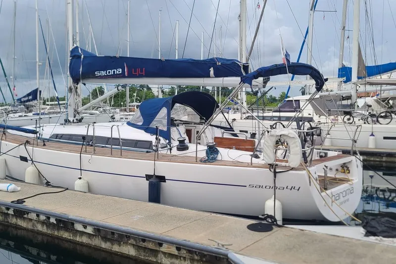 The Image of 2015 Salona 44 yacht docked at marina, featuring sleek design and blue sail cover. - 1