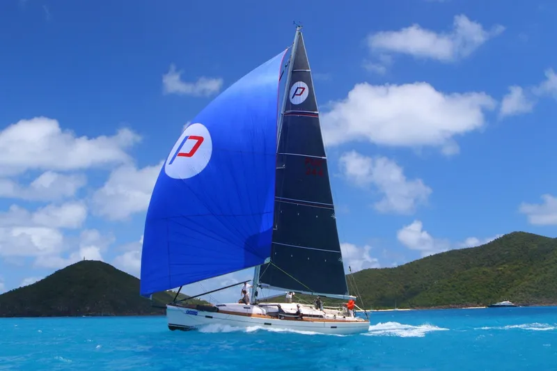 Slide: The Image of Sailing yacht Salona 44 (2015) with blue spinnaker on turquoise sea, clear sky background. - 17