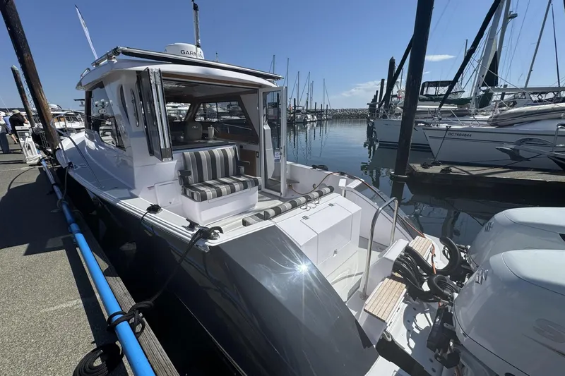 Slide: The Image of 2022 True North 34 Outboard Express docked at marina, showcasing sleek design and modern features. - 3