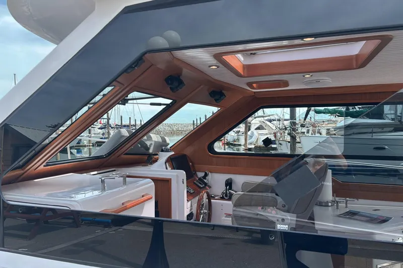 Slide: The Image of Interior view of 2022 True North 34 Outboard Express yacht at marina. - 4