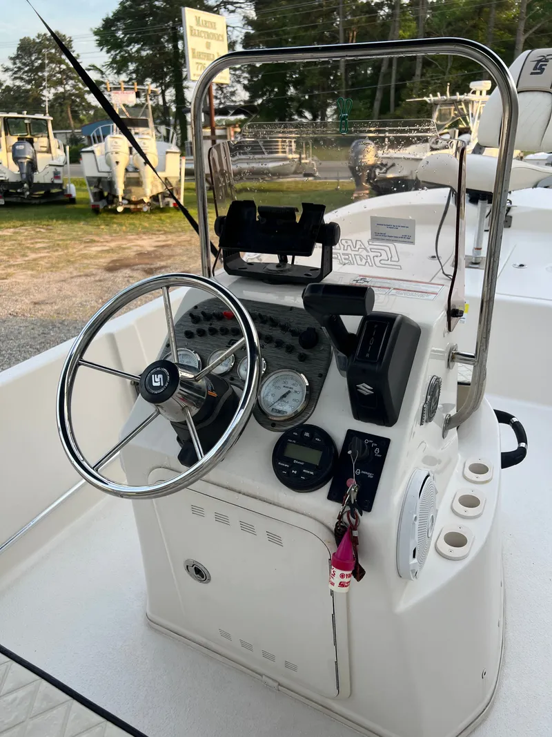 Slide: The Image of The helm of a Carolina Skiff 192 JLS boat with steering wheel and instruments. - 3