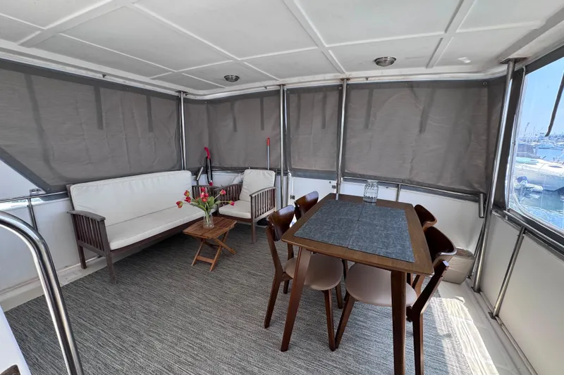 Slide: The Image of Enclosed deck of 1987 Fair Weather Mariner 38 with seating and dining area. - 28