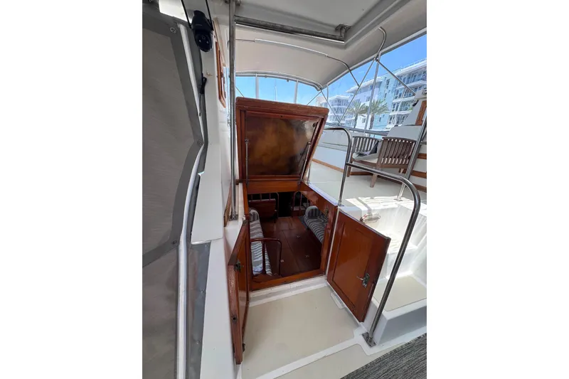 Slide: The Image of 1987 Fair Weather Mariner 38 yacht interior with open wooden hatch and seating area. - 29
