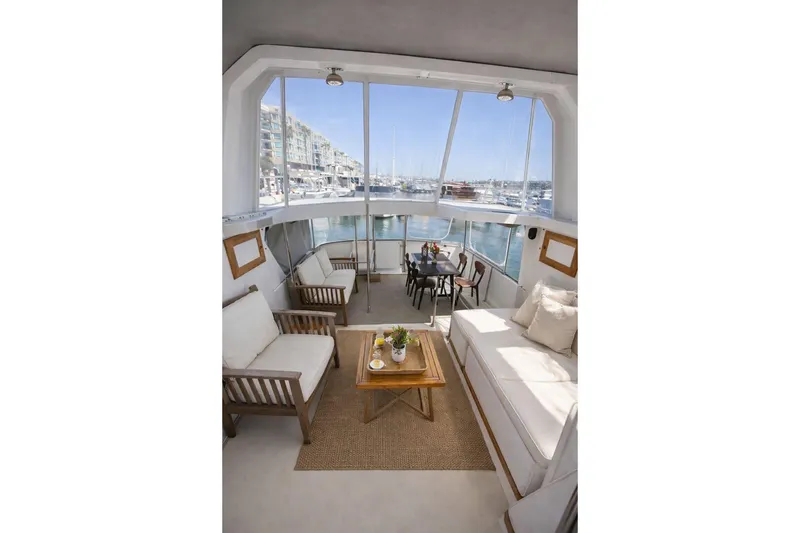 Slide: The Image of Interior of 1987 Fair Weather Mariner 38 yacht with elegant seating and marina view. - 25