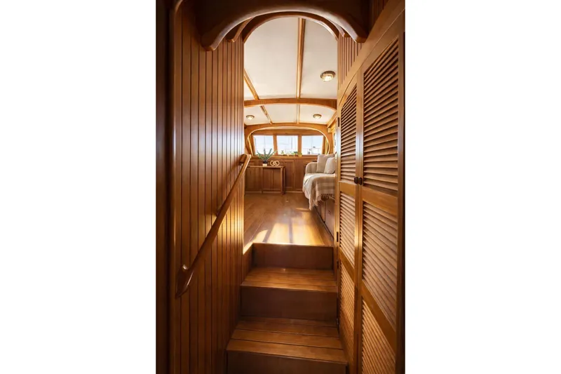 Slide: The Image of Interior of 1987 Fair Weather Mariner 38 yacht with wooden paneling and cozy seating area. - 27