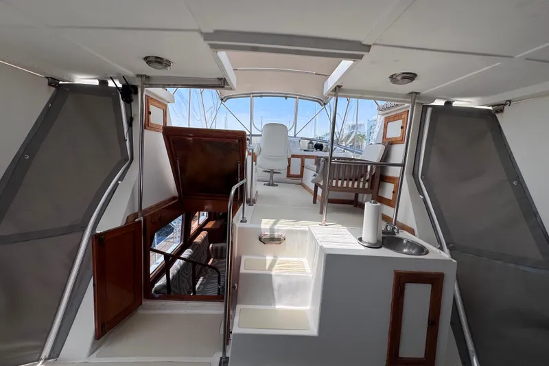Slide: The Image of Interior view of a 1987 Fair Weather Mariner 38 yacht, featuring seating and helm area. - 22