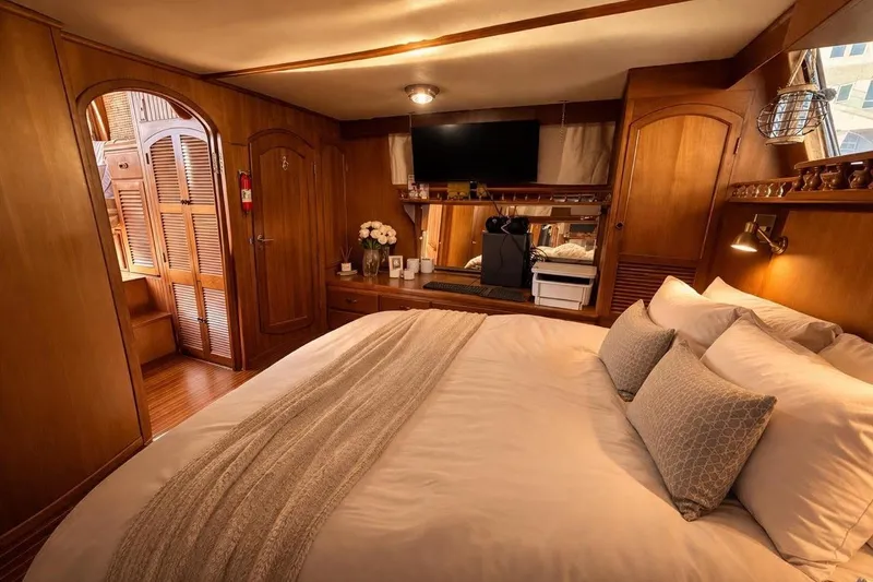 Slide: The Image of Luxurious cabin interior of 1987 Fair Weather Mariner 38 yacht, featuring cozy bedding and elegant wood finishes. - 15