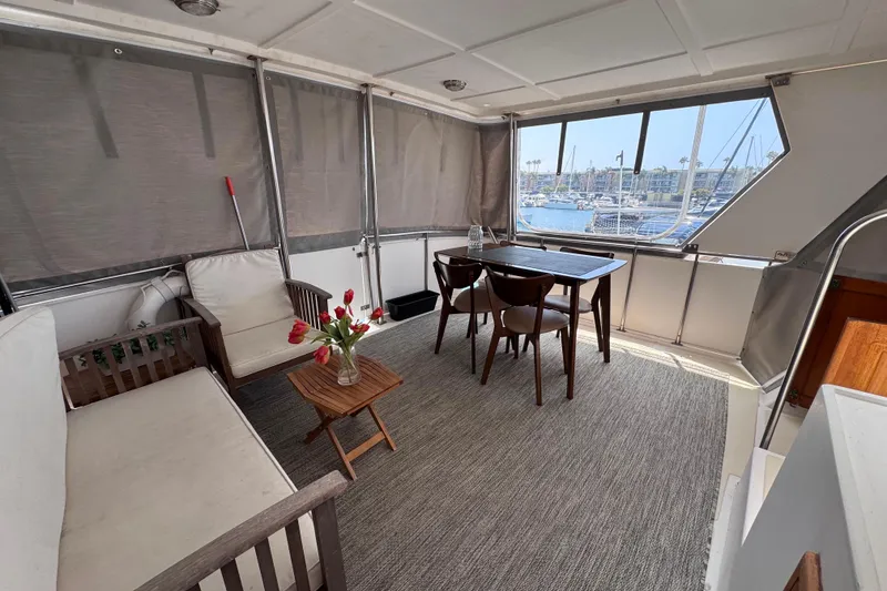 Slide: The Image of Interior of 1987 Fair Weather Mariner 38 yacht with seating and marina view. - 24