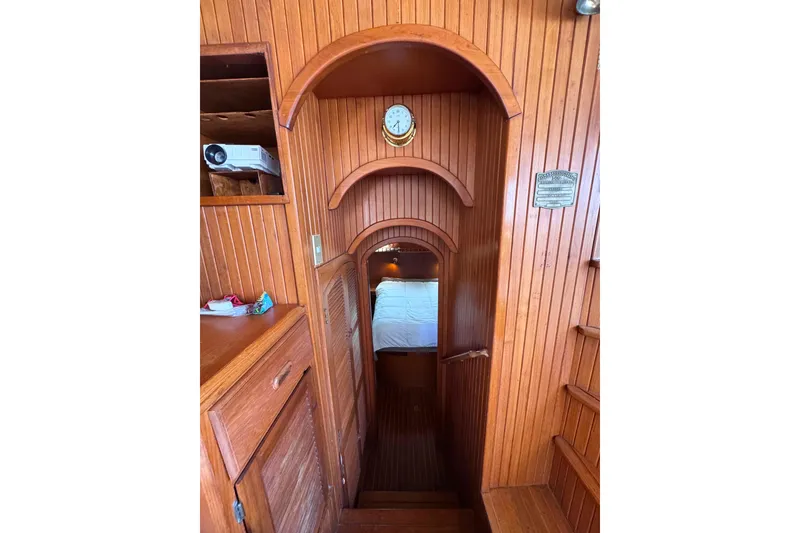 Slide: The Image of Interior of 1987 Fair Weather Mariner 38, featuring wooden paneling and cozy cabin entrance. - 18