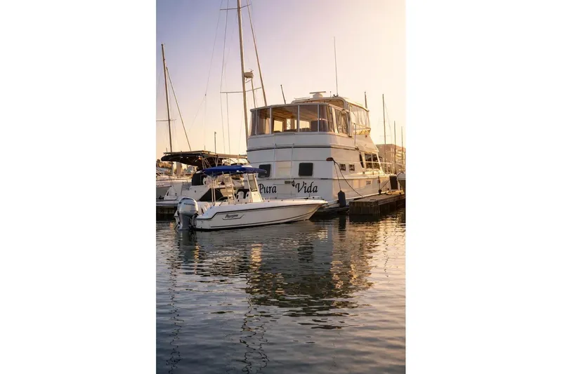 Slide: The Image of 1987 Fair Weather Mariner 38 yacht docked at sunset, reflecting on calm water. - 16