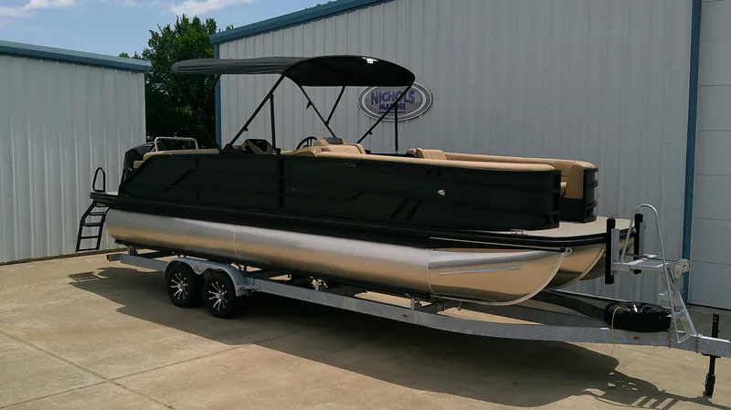 Slide: The Image of Evotti 525 QL pontoon boat 2026 on trailer outside building. - 3
