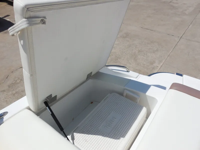 Slide: The Image of 2011 Cobalt 200 boat with open storage compartment and cooler. - 24