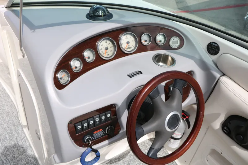 Slide: The Image of Dashboard of a 2005 Chaparral 220 SSi boat with wood trim. - 41
