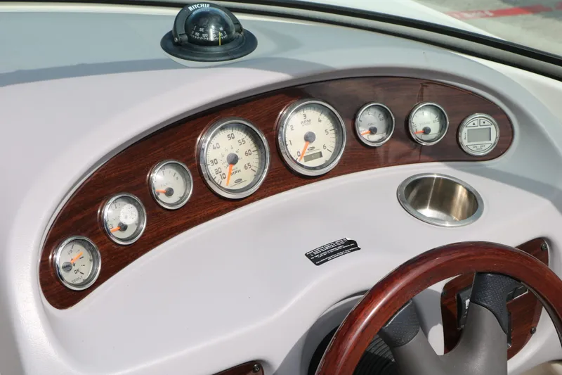 Slide: The Image of Dashboard of a 2005 Chaparral 220 SSi boat with wood trim. - 42