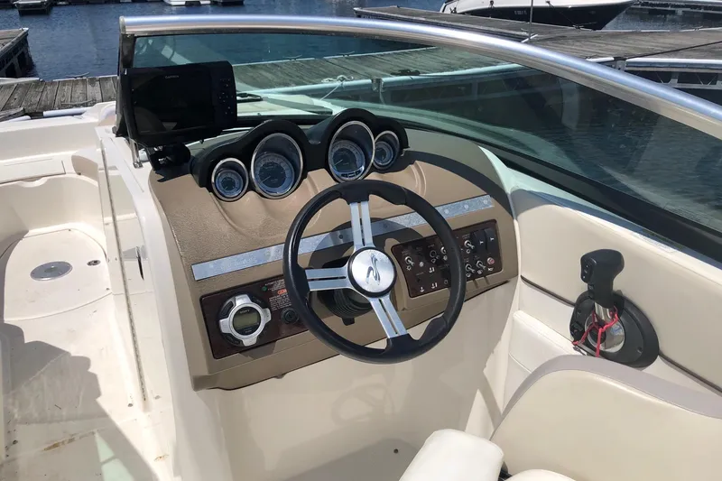 Slide: The Image of Cockpit of 2013 Sea Ray 260 Sundeck with steering wheel and control panel. - 11